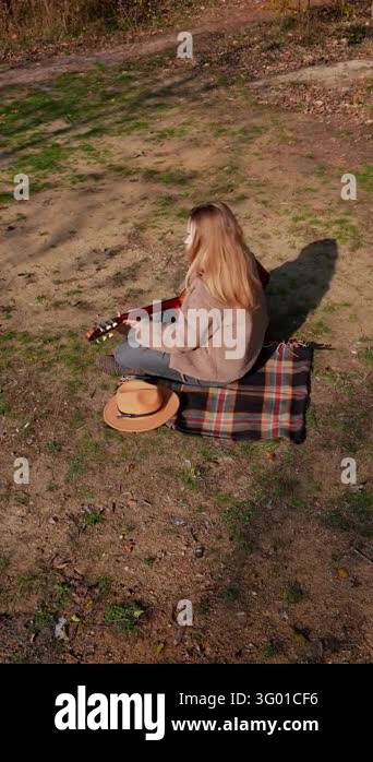 Instrument Land Portrait of smiling caucasian artist plays wooden acoustic guitar in ...