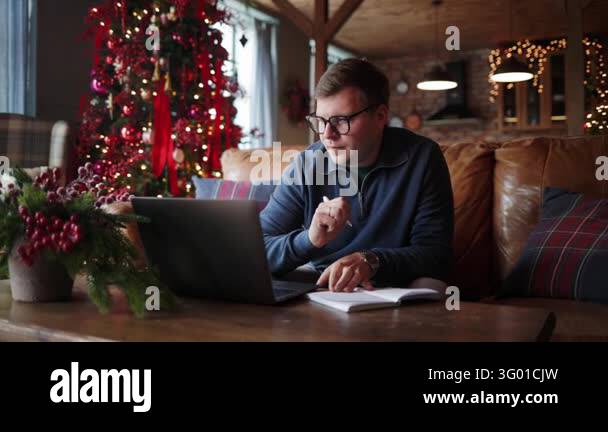 Young man attends an online learning session at home, listening ...