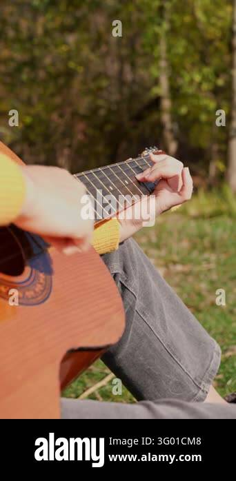 Instrument Land Close up of hands playing acoustic guitar and singing relaxing enjoying ...