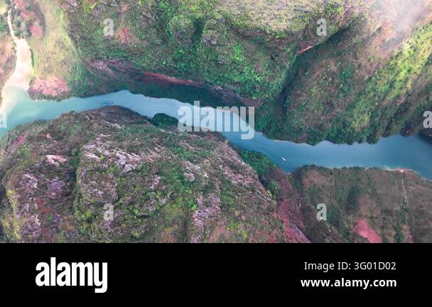 An aerial view follows the Nho Que River through mountain valleys on ...