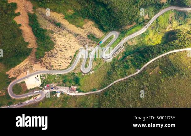 An aerial view follows the Ha Giang Loop through mountain terrain in ...