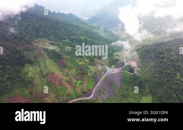 An aerial view follows a winding road through the Ha Giang Loop in ...