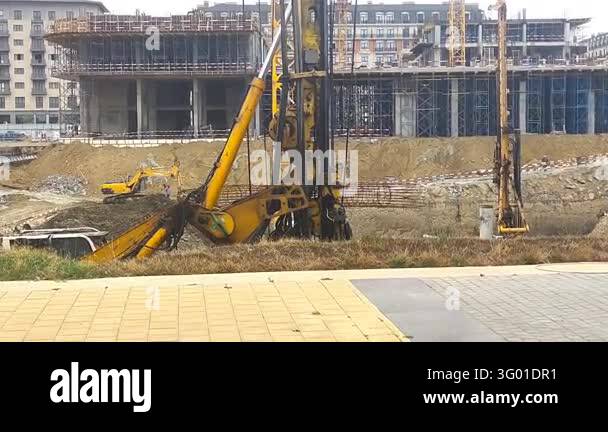 Heavy construction machinery working at a large construction site in ...
