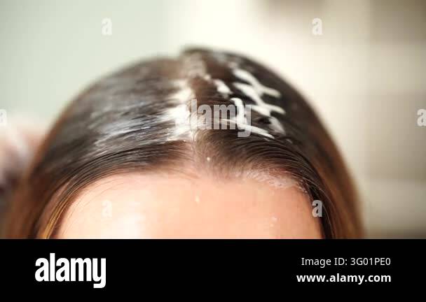 Hair Color Easy For Roots Close up view of applying hair dye to roots. Professional coloring ...
