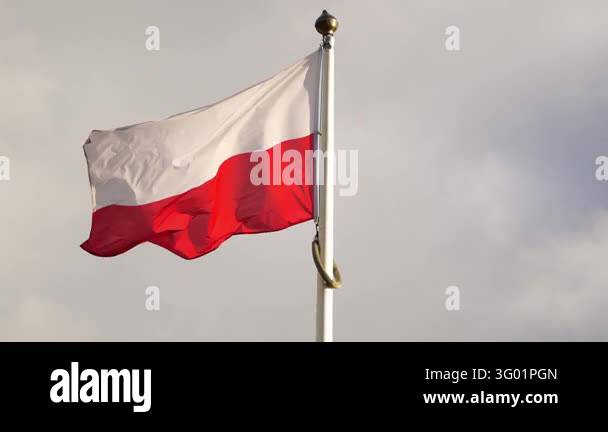 National flag of Poland fluttering in the wind against a cloudy sky ...