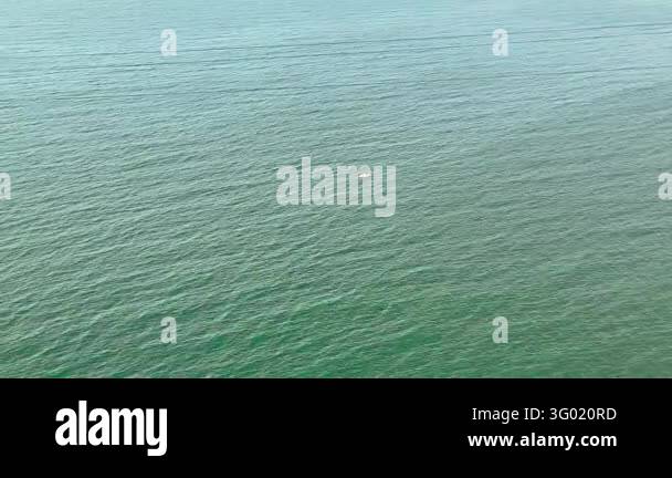 Smlll Image Tiny boat sailing on the sea. An aerial view showing a small vessel ...
