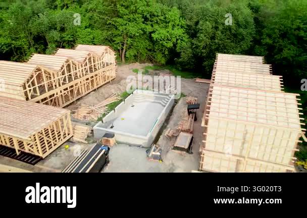 Pool Wiver Timber cabin complex with swimming pool being built near woodland ...