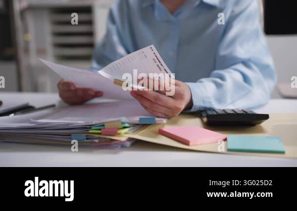 Office professional reviewing printed financial reports with colorful ...