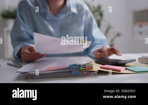 Testing Reporting Workflow Office professional checking printed financial reports organized with ...