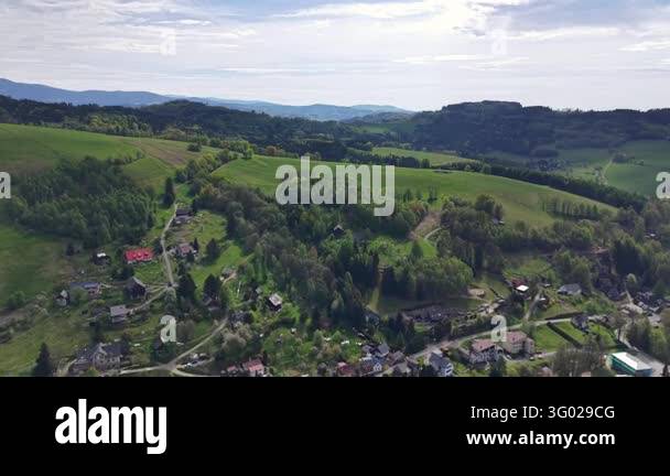 Smlll Image Elevated wide view shows rolling green hills, patchwork farms, small ...