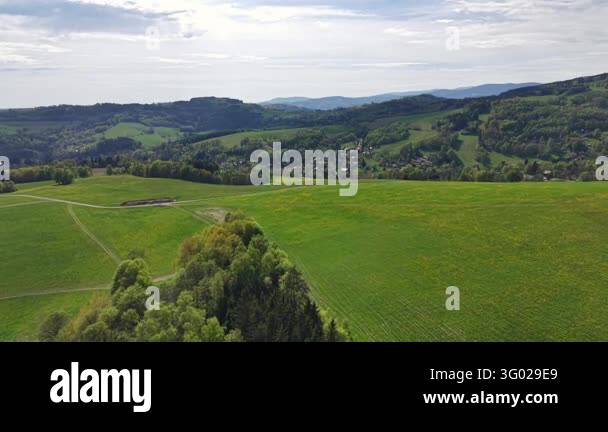 Smlll Image High above countryside, rolling green hills form patchwork fields ...