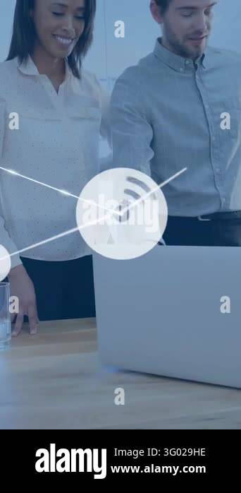 Vertical video: Colleagues leaning over laptop, man pointing and ...