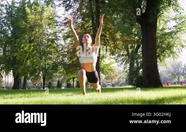 Fitness routine. Outdoor yoga. Slim athletic female performing active ...