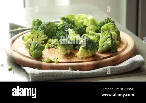 Woman Hands Cutting Broccoli into Florets on Wooden Cutting Board Stock ...