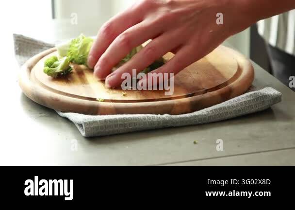 Woman Hands Cutting Broccoli into Florets on Wooden Cutting Board Stock ...