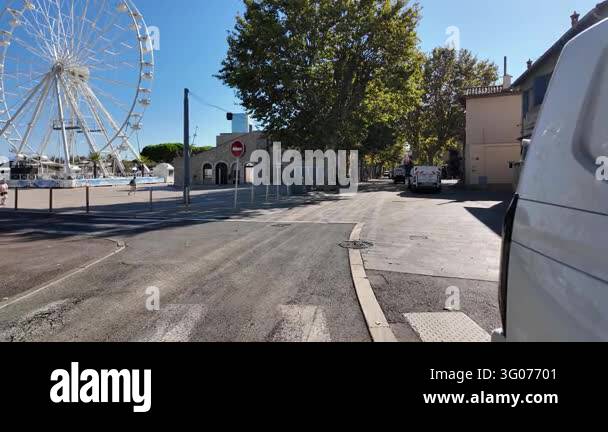 France Tree Antibes, France - September 15, 2026 - A sunny town square with a ...