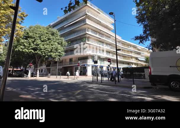 France Tree Antibes, France - September 15, 2026 - Pedestrians pass a modern ...