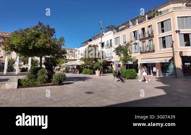 France Tree Antibes, France - September 15, 2026 - Pedestrians cross a sunny urban ...