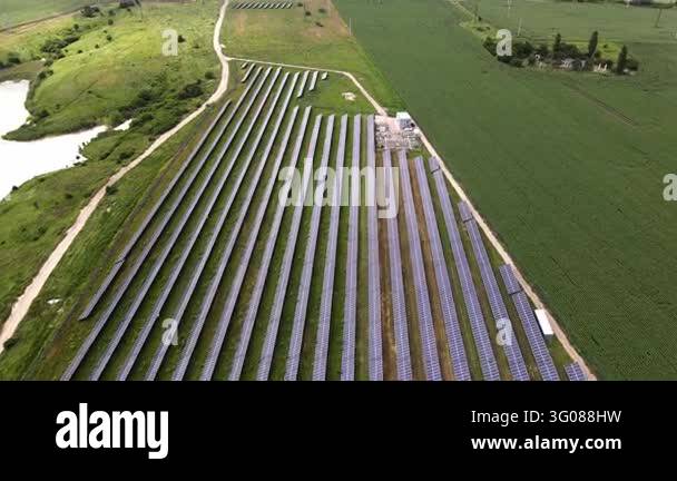 Power Generations Large solar farm with rows of panels generating clean, renewable energy ...