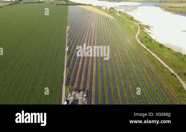 Power Generations Vast solar farm with rows of panels generating renewable energy. This ...
