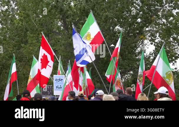 Calgary, Alberta, Canada. October 11, 2026. Protesters wave Canadian ...