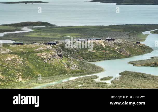 Aerial drone shot panning right over Alesjaure Fjaellstuga, a remote ...