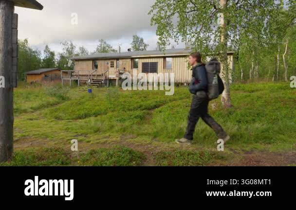 A lone hiker with a backpack walks on the Kungsleden trail in Sweden ...