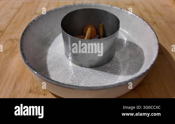 Placing a Vegetable and Mushroom Mixture in a Food Ring -- A mixture of ...
