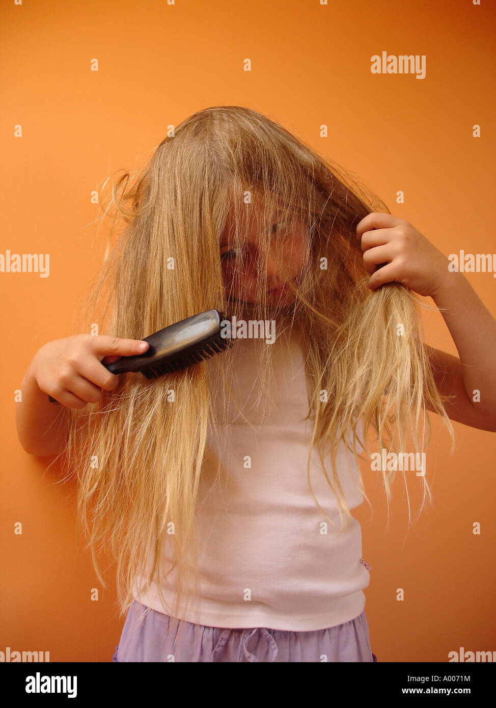 8 Year Old Girl Having Her Very Tangled Hair Brushed Stock Photo