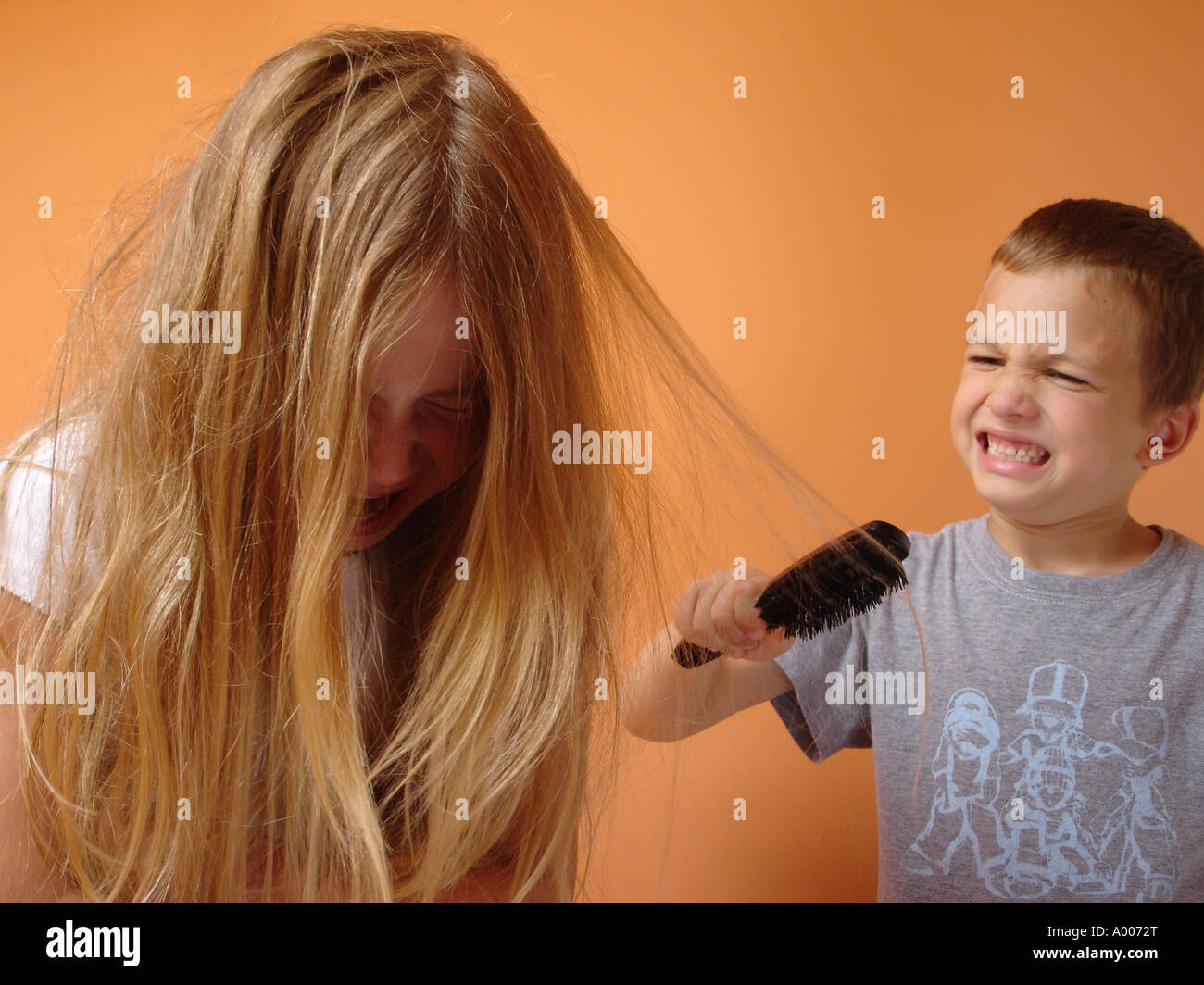 8 Year Old Girl Having Her Very Tangled Hair Brushed Stock Photo