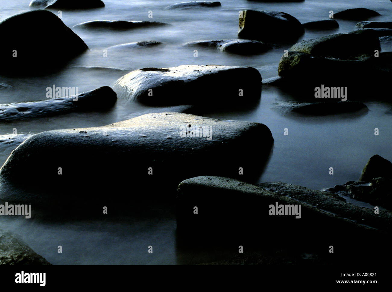 Rocks along coast at low tide Stock Photo