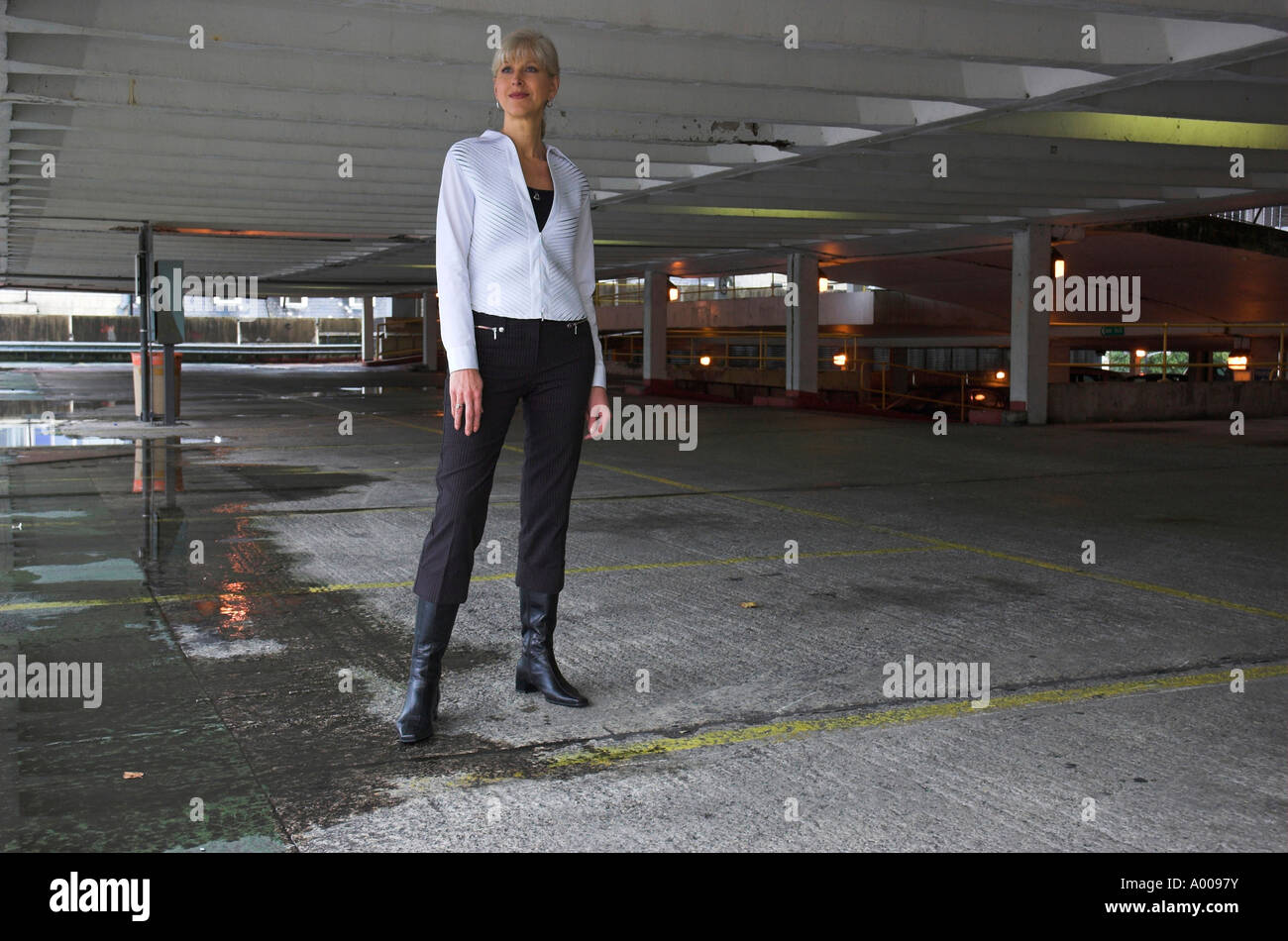 Attractive mature business woman in empty car park Stock Photo