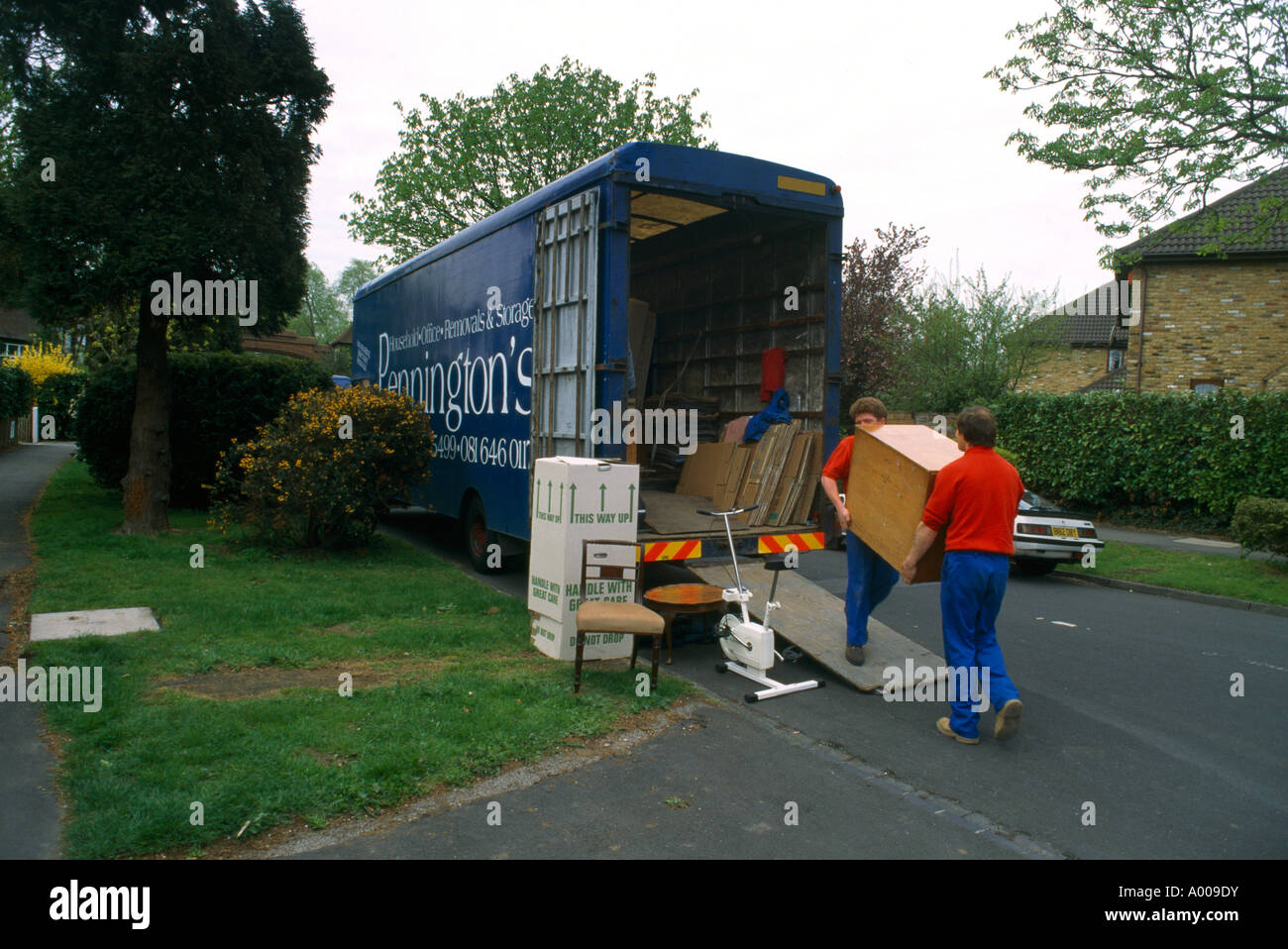 Removal Men Moving Furniture into Lorry Stock Photo