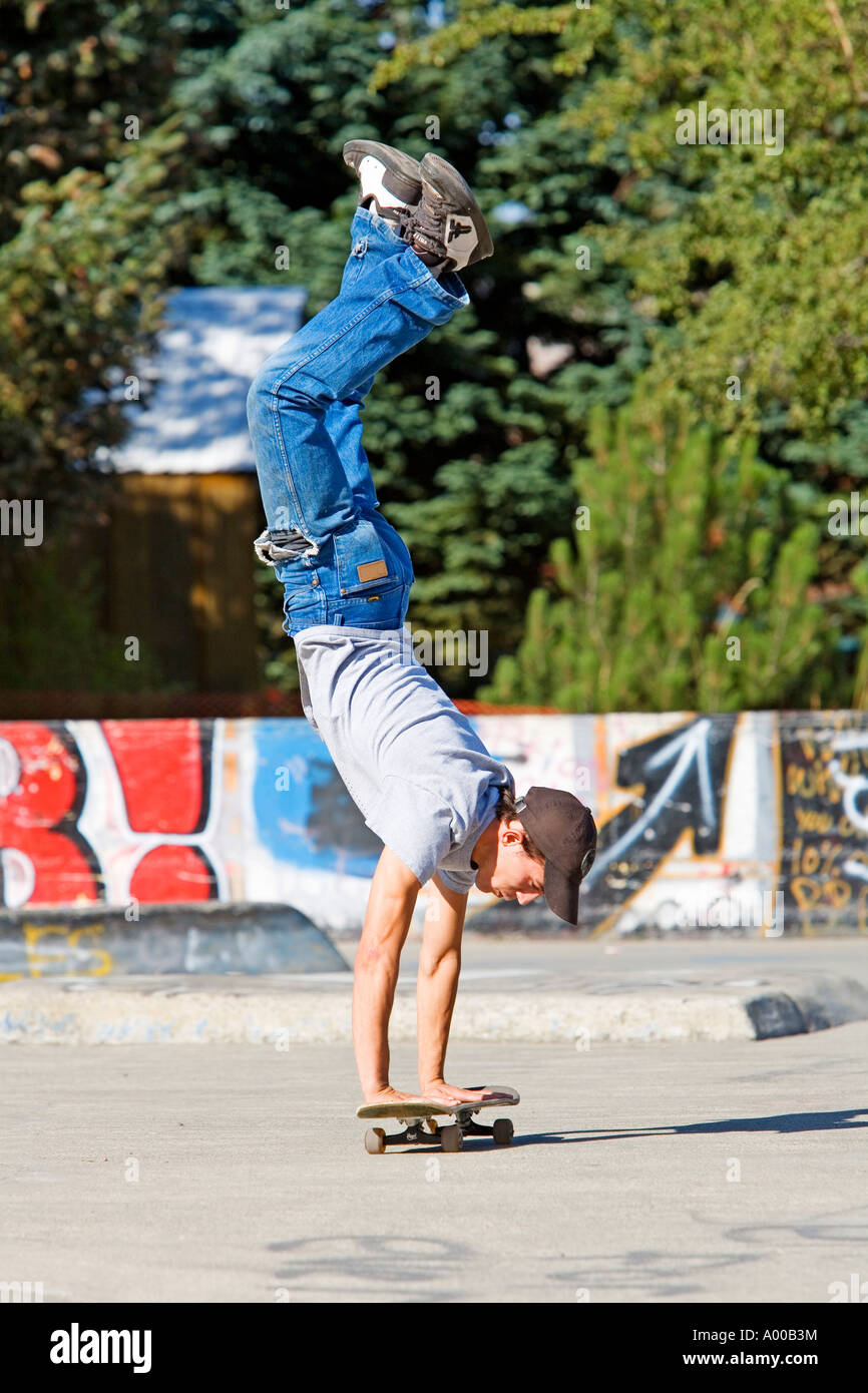 Image of a teenage boy doing a handstand on a skateboard Stock Photo - Alamy