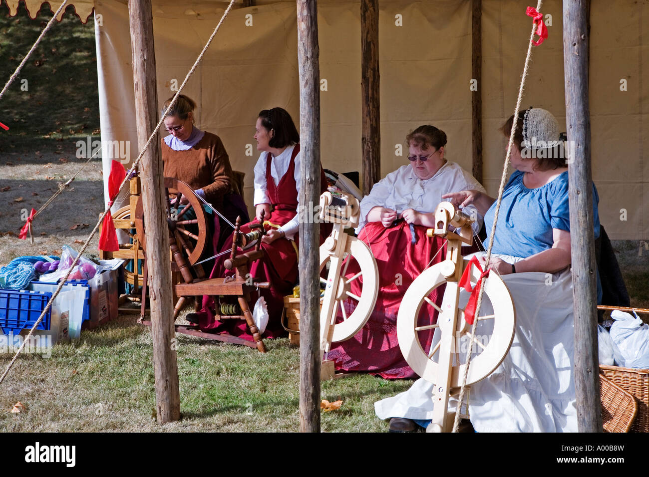 Image of a group of four women dressed in pioneer clothing all working