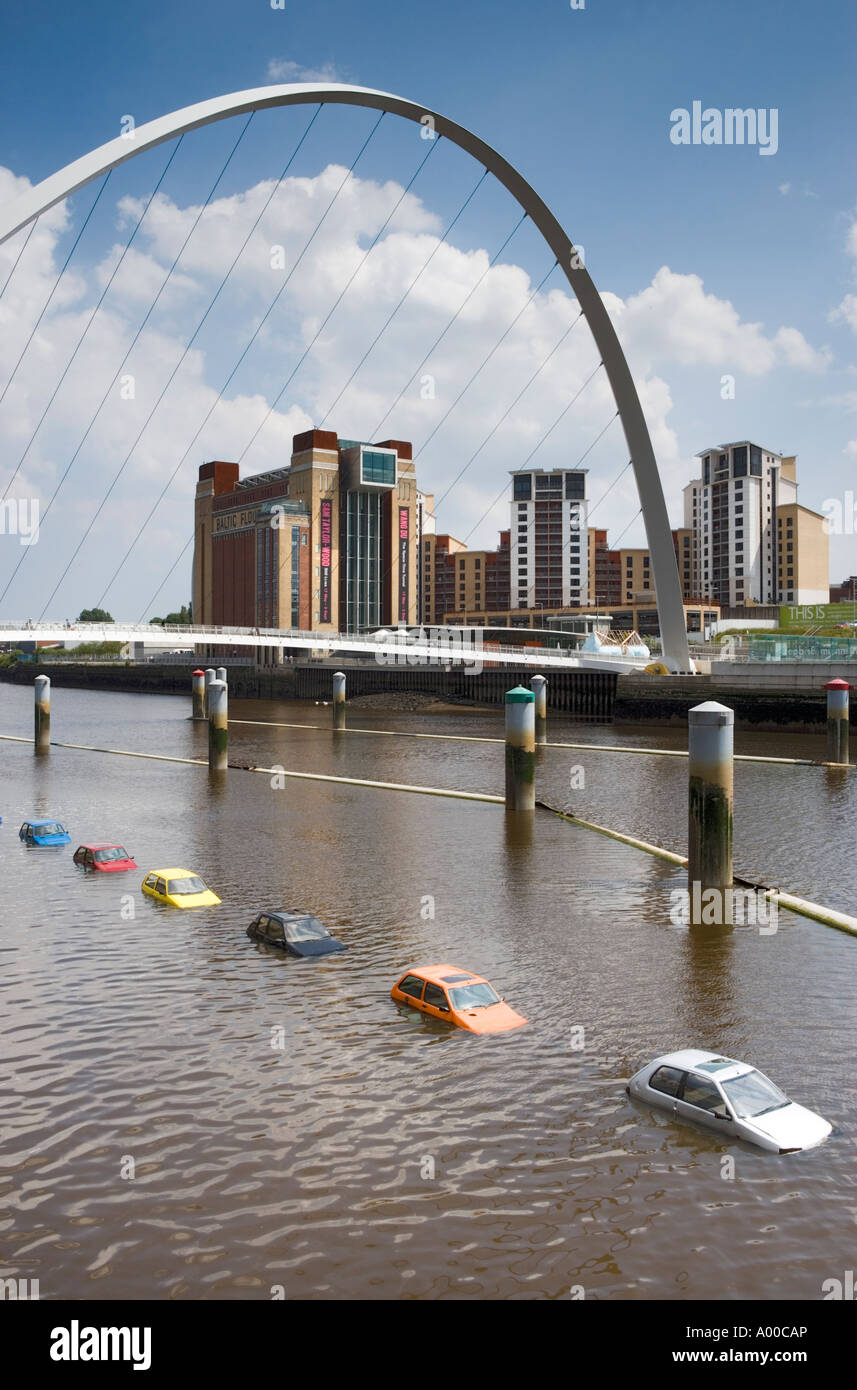 Cars floating under the Millenium bridge in the River Tyne between