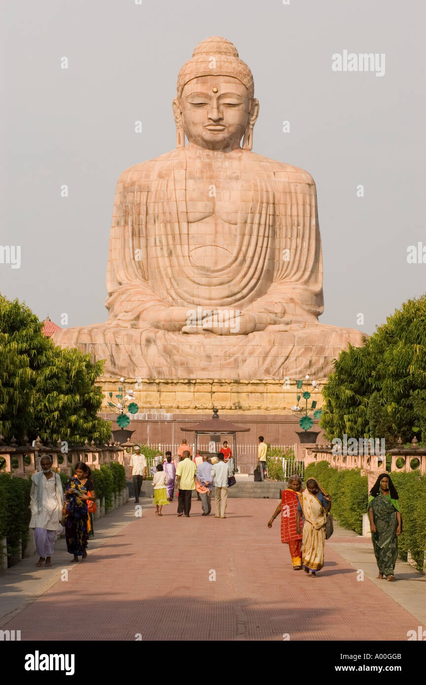 Pilgrims at giant limestone statue of Buddha in Bodhgaya Bihar India Stock Photo