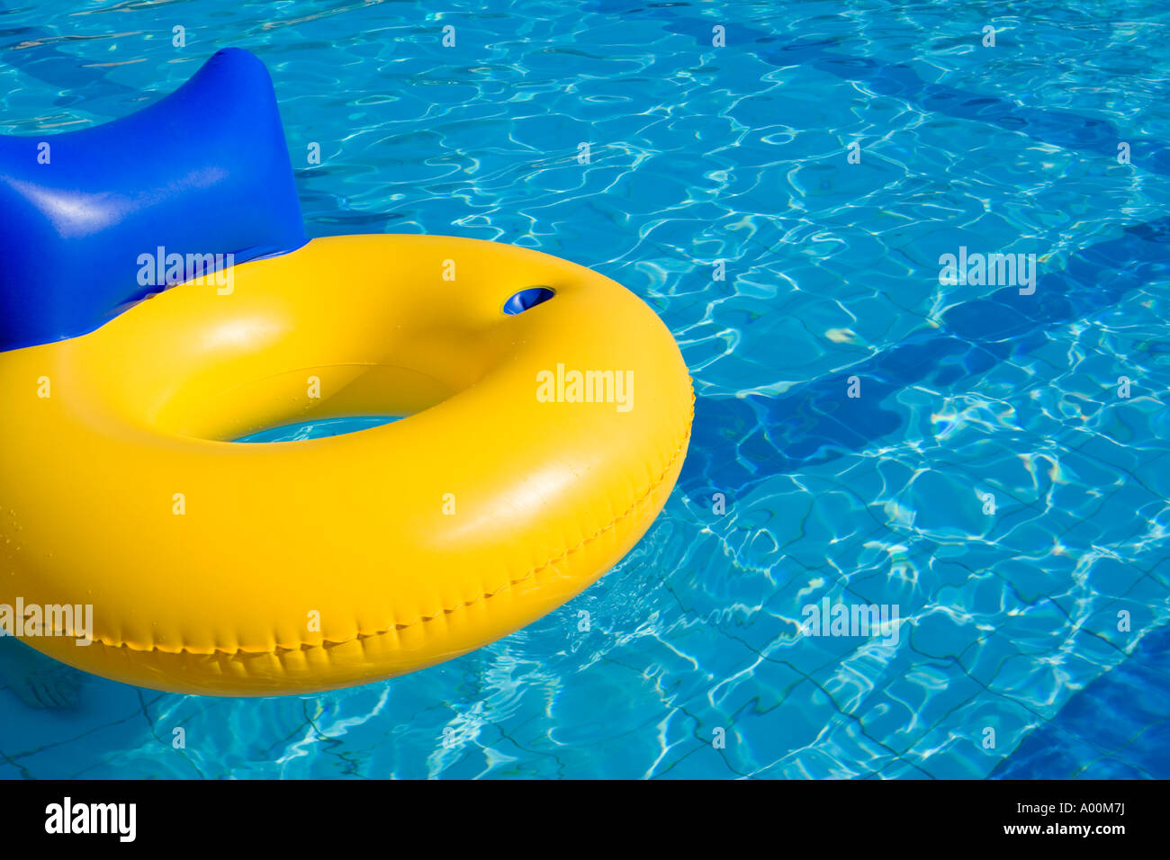 RUBBER RING WITH BACKREST IN A SWIMMING POOL Stock Photo - Alamy