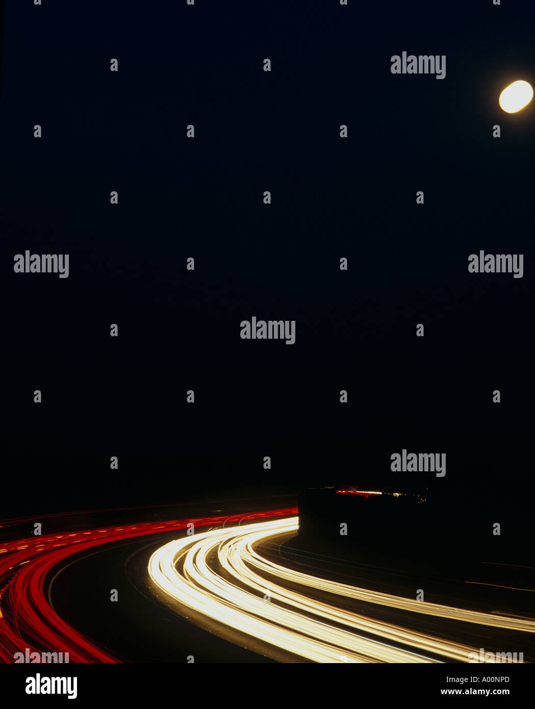 Traffic flow under a full moon, M56, Cheshire, UK Stock Photo
