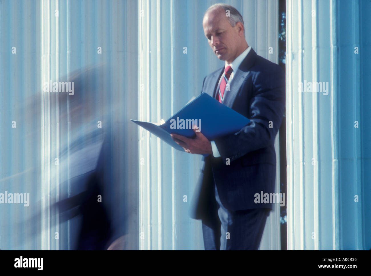 businessman and woman on steps of office building Stock Photo