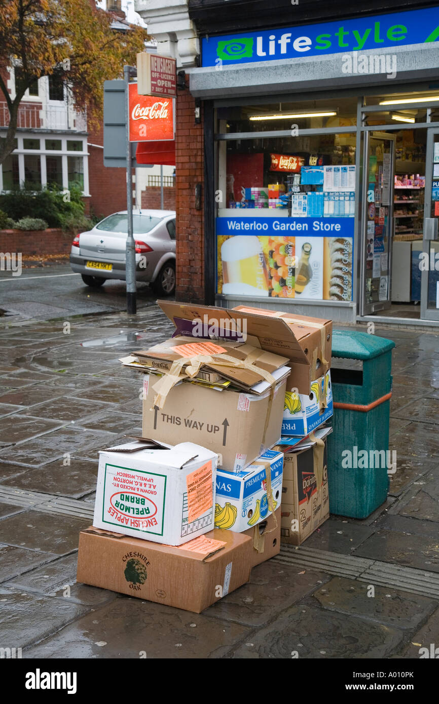 Cardboard boxes of rubbish for commercial collection on pavement in