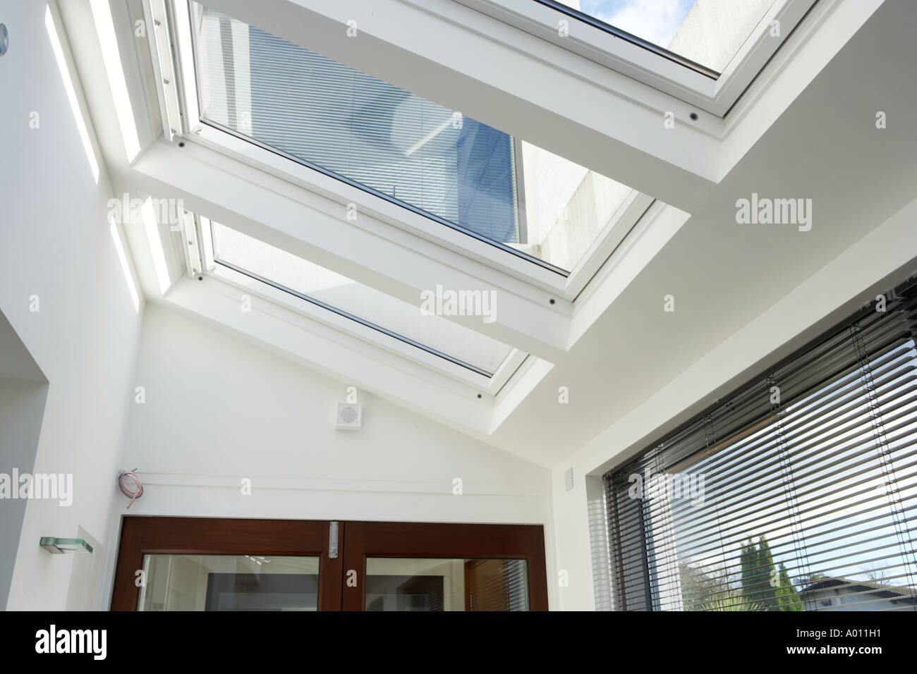 automatic velux windows in conservatory of new open plan house Stock Photo