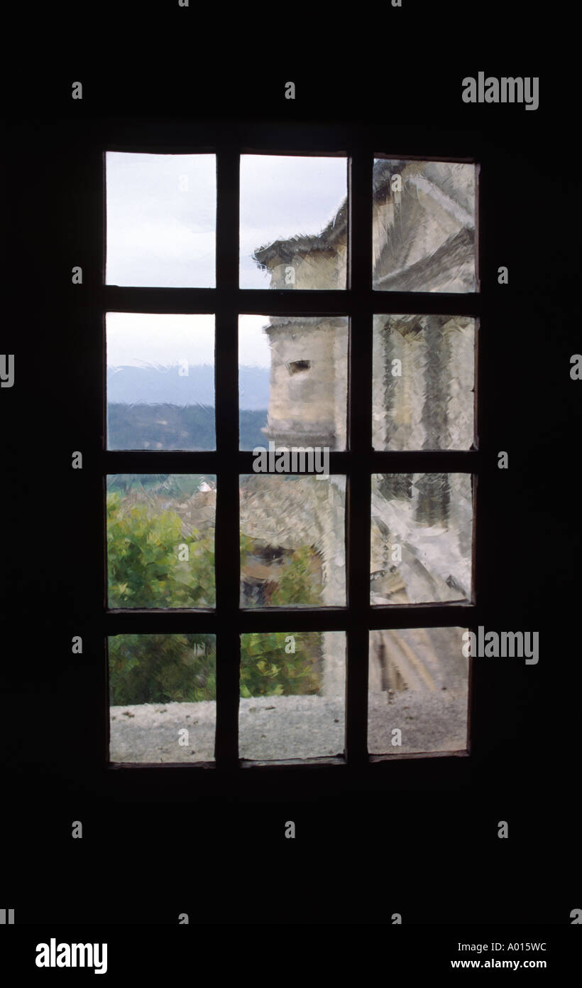 A RENAISSANCE CHATEAU as seen through an old glass window in the rural ...