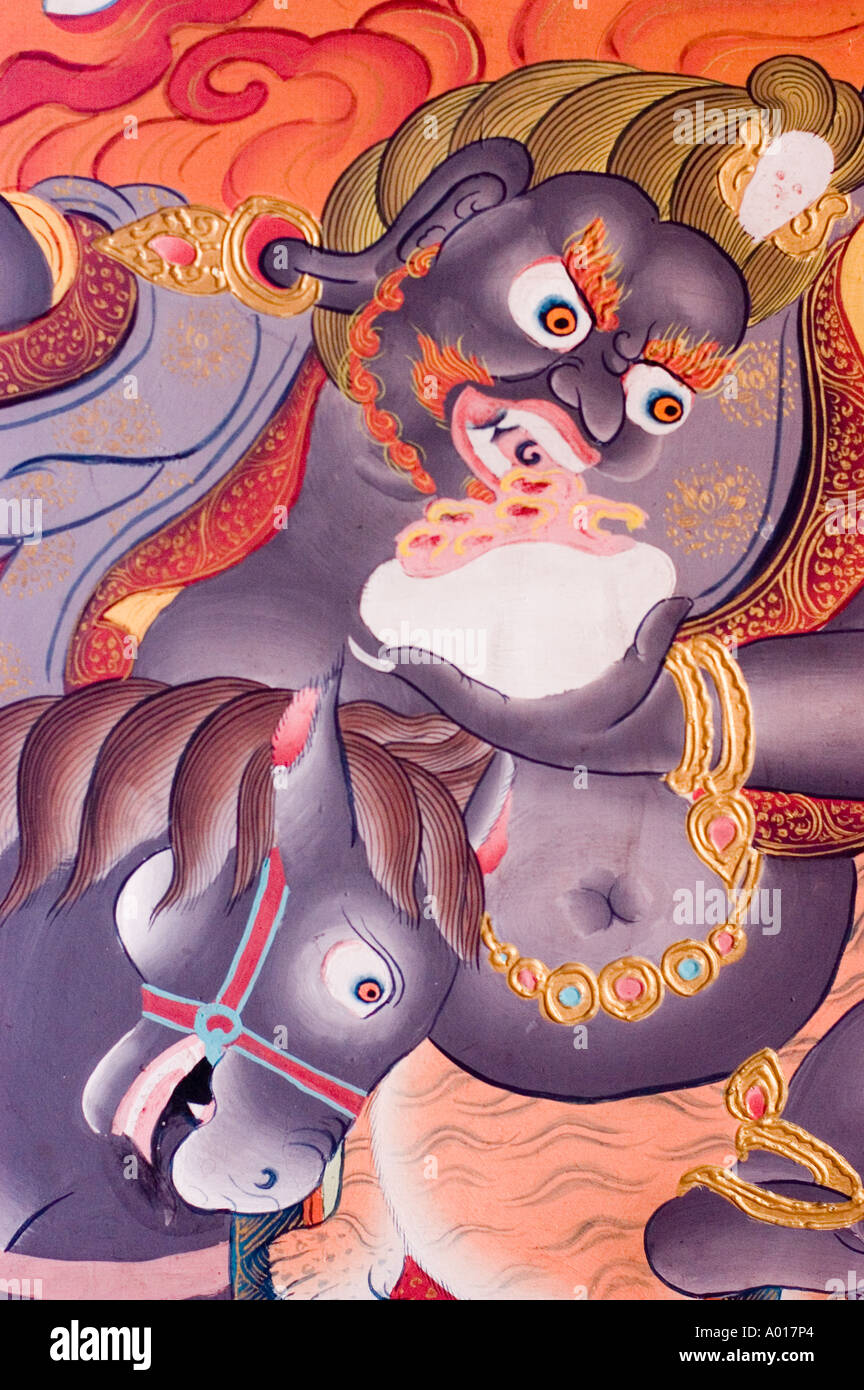 Blue buddhist protector face closeup eating meat from skull paintings