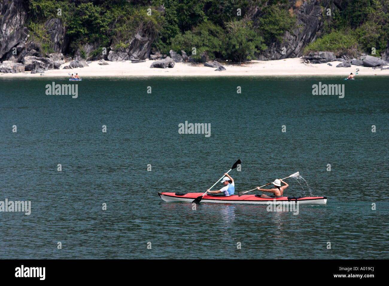Two young women kayaking at Monkey Island off Cat Ba Island Halong Bay Vietnam Stock Photo Alamy