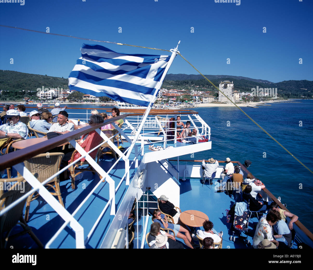 Greece, GR-Ouranopouli, Chalkidiki, Macedonia Central, city panorama, tourist ship, excursion ship, Greek flag Stock Photo