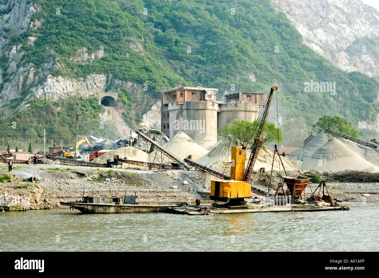 Heaps of crushed construction materials being prepared on the bank of the Yangtze river, Nanjing, China Stock Photo