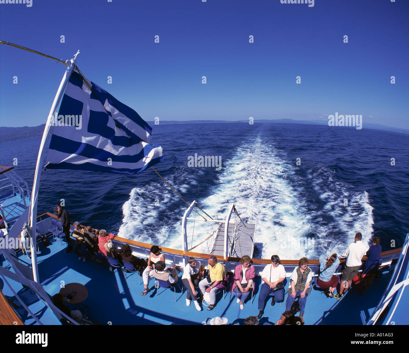 excursion ship, Greek flag, tourists, water tossed up by a ship, foaming sea, Aegean Sea Stock Photo