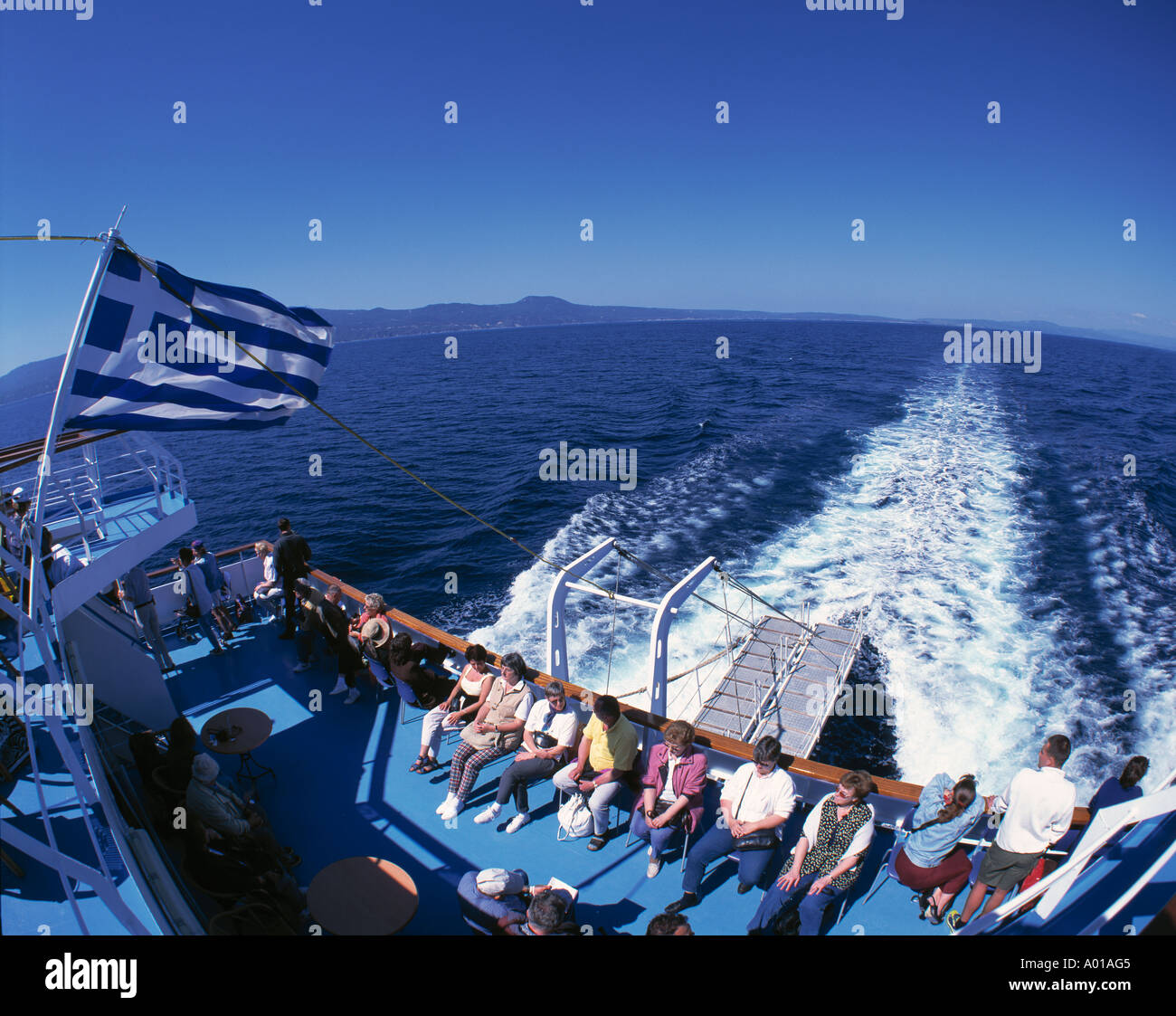 excursion ship, Greek flag, tourists, water tossed up by a ship, foaming sea, Aegean Sea Stock Photo