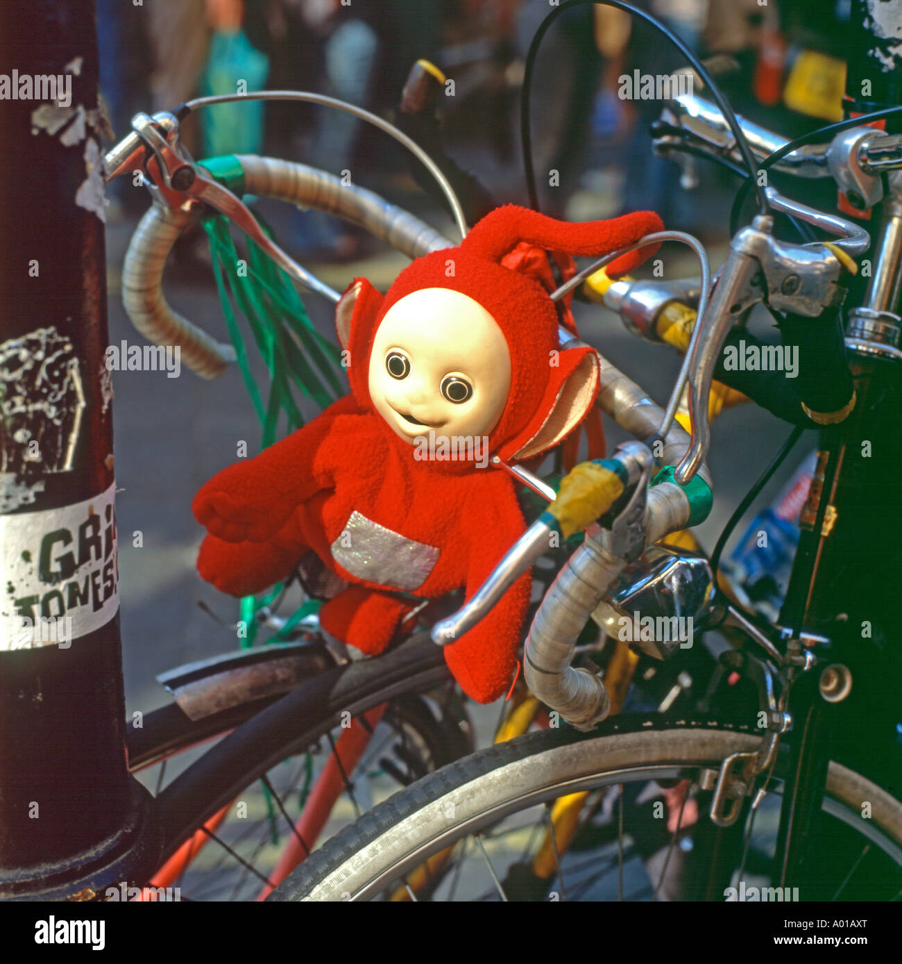Teletubby Po one of the four teletubbies childrens TV character as a mascot on a bicycle in Brick Lane London England UK    KATHY DEWITT Stock Photo